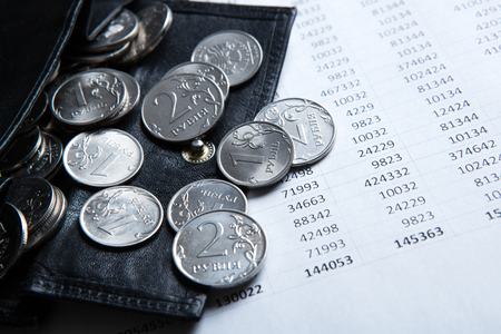 pocket purse with ruble coins on a document with numbersの写真素材