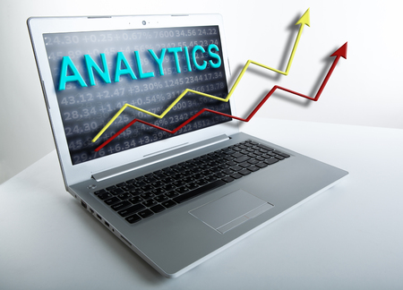 notebook keyboard and graphics and digits on a grey backgroundの写真素材