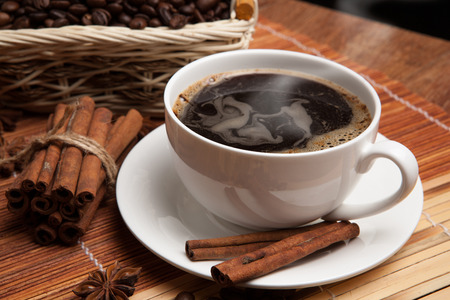 cup of coffee, spice and roasted beans in the basketの写真素材