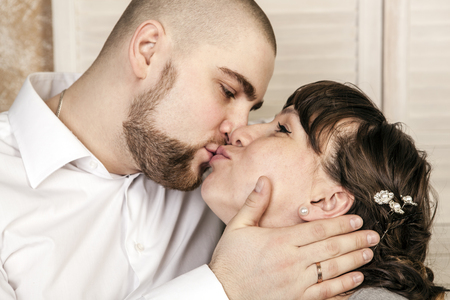 Man and woman kissing at the weddingの写真素材