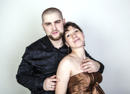 Man and woman hugging on a gray backgroundの写真素材