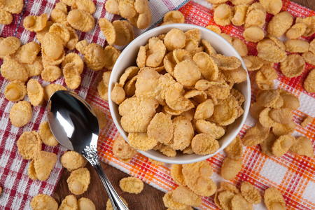 pile of cornflakes and a spoon close upの写真素材