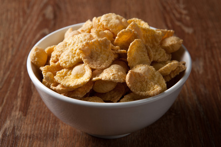 Bowl with popcorn on a wood table close upの写真素材