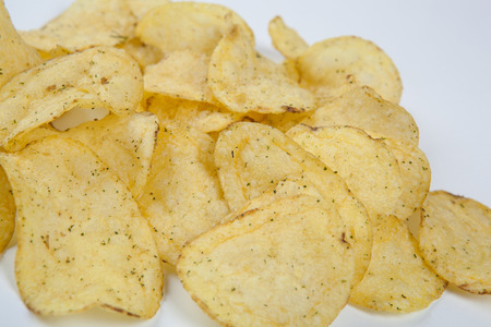 bunch of fried potato chips on white close upの写真素材