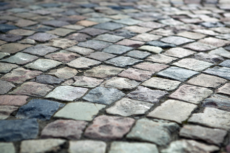 Abstract background of old cobblestone pavement close upの写真素材