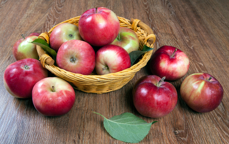 Still life of many apples on a napkin in the basket on a wooden tableの写真素材