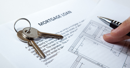 apartment keys, apartment plan, mortgage loan document and human handの写真素材