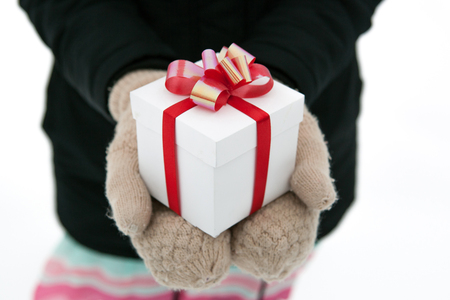 Female hands give you a gift box close upの写真素材