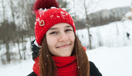 A young girl in winter clothes is smilingの写真素材