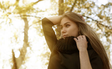 girl on a background of autumn treesの写真素材