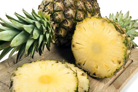 Slices of pineapples on a cutting board closeupの写真素材