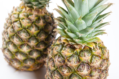 two big pineapples on a white background closeupの写真素材