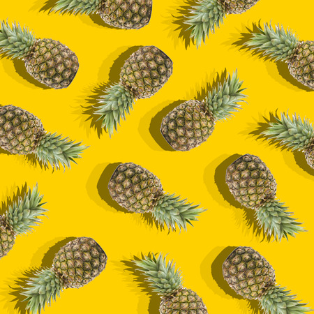 illustration in the form of yellow background with image of ripe pineapplesの写真素材