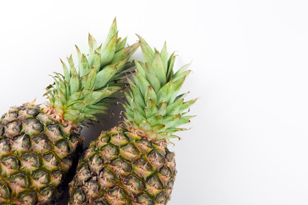 two big pineapples on a white background closeupの写真素材