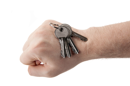 keys to the apartment on the fist of the hand isolatedの写真素材