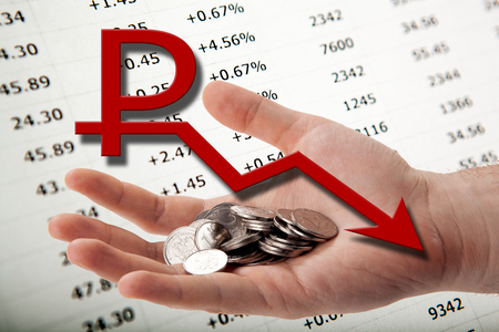 illustration with a symbol of the ruble, a diagram, a person's hand with ruble coinsの写真素材