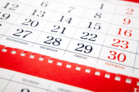 big pile of printed wall calendar sheets closeupの写真素材