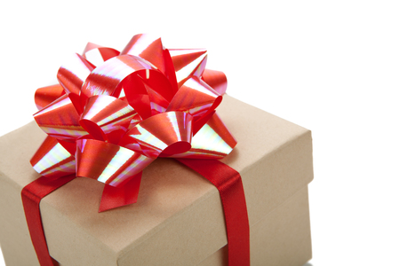 One festive gift box with a red bow on a whiteの写真素材