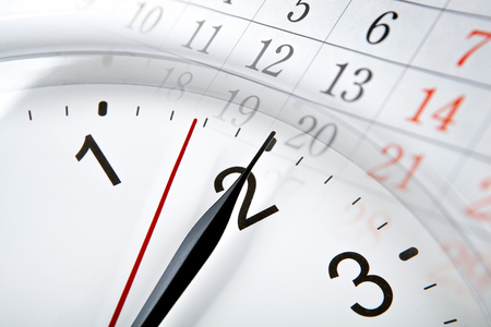 wall calendar with the number of days and clock closeupの写真素材