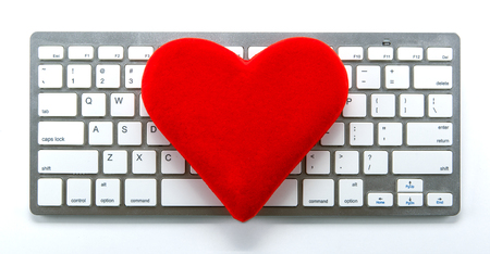 symbol of a red heart on the keyboard as a dating symbol closeupの写真素材