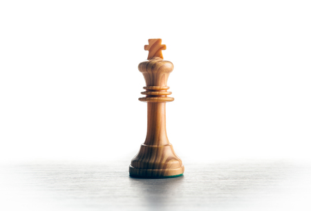 chess piece of a white king on a chessboard on a white background close upの写真素材