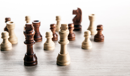 chess pieces on a grey background and black and white chess kings close upの写真素材