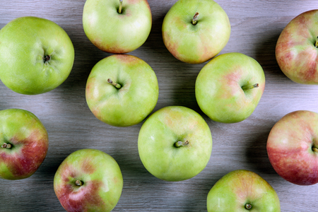 fresh apples on a gray wooden background close upの写真素材