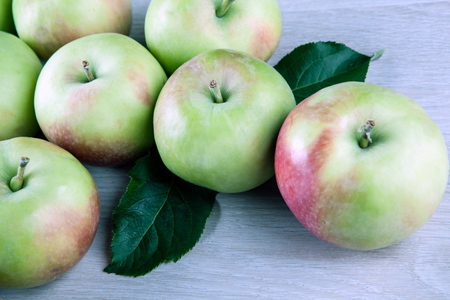 fresh apples on a gray wooden background close upの写真素材