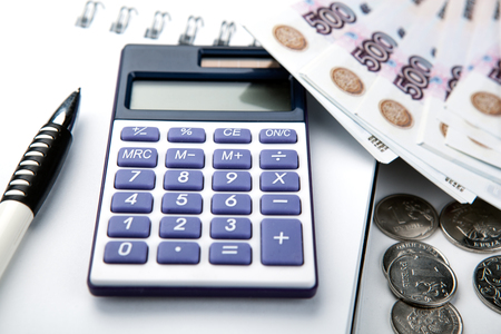 business still-life from a calculator and a bundle of russian banknotes 500 ruble close upの写真素材