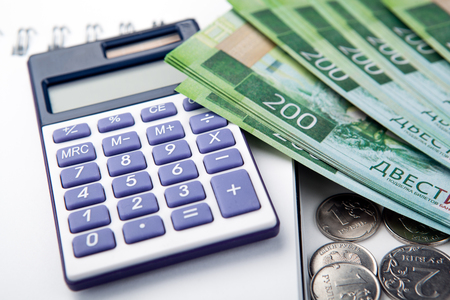 business still-life from a calculator and a bundle of russian banknotes 200 rubles close upの写真素材