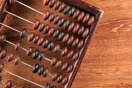 antique abacus on a wooden table as a background close upの写真素材
