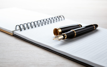 fountain pen on the scratchpad on the desktop  close up