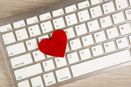 red heart on a white keyboard top view