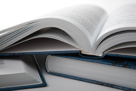 open books with other books on a gray table close upの写真素材