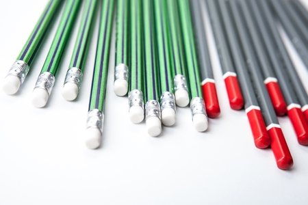 many simple pencils in a row on a white table close upの写真素材
