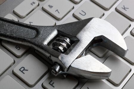 one big wrench and a computer keyboard close up