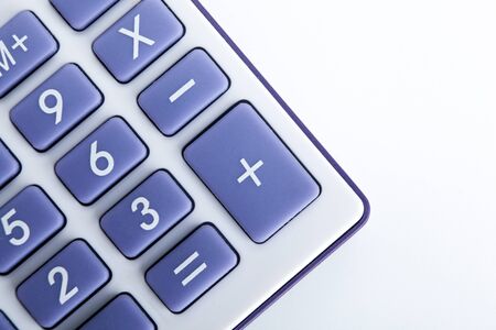 calculator with blue buttons on a white background top viewの写真素材