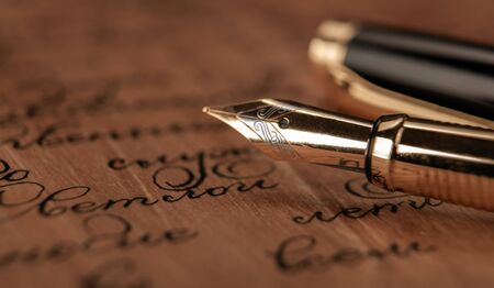 fountain pen on paper with ink text on the wooden desk closeupの写真素材
