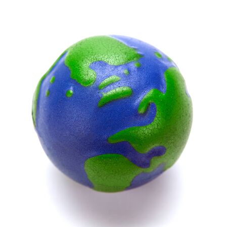 rubber ball in the form of a globe of the planet earth in the hand of manの写真素材