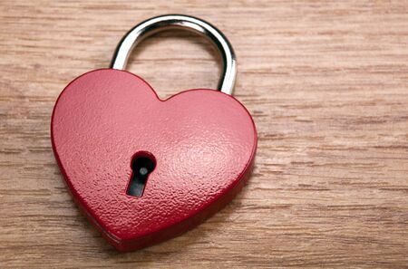 heart shaped padlock on wooden background closeupの写真素材