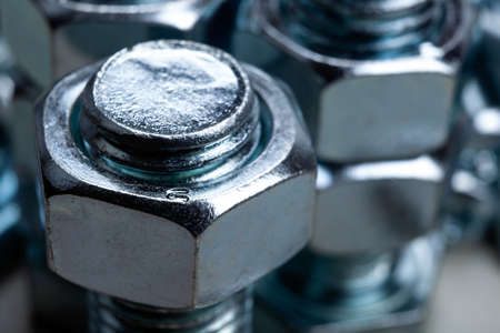 large steel nuts, screwed on a bolt closeupの写真素材