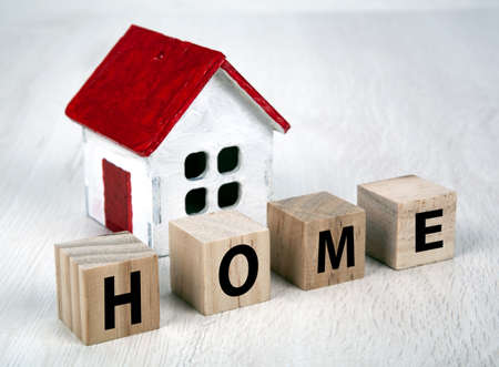 small white wooden house and cubes with the inscription home closeupの写真素材