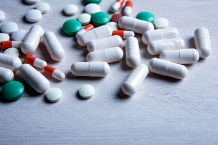 multicolored medical pills are scattered on the table closeupの写真素材
