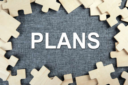 puzzle elements on a textile background as a riddle and inscription plans top viewの写真素材