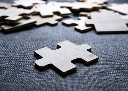 One puzzle piece against the background of other pieces closeupの写真素材