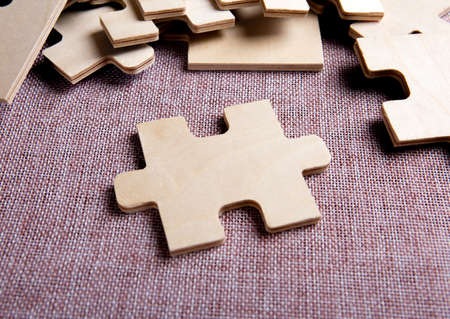 puzzle elements on a textile background as a riddle closeupの写真素材