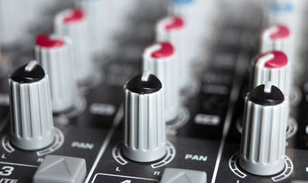 sound mixer and many faders close up music studio