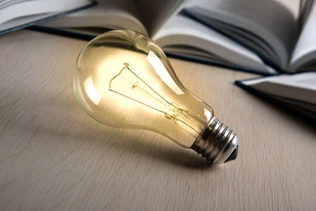 burning glass bulb on the background of booksの写真素材
