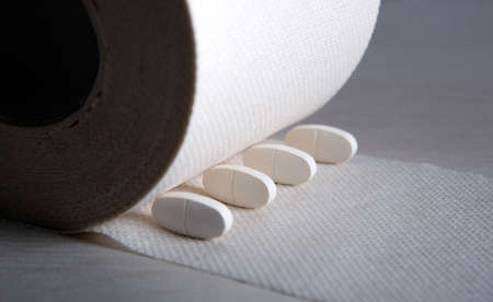 toilet paper roll with white pillson on the table close upの写真素材