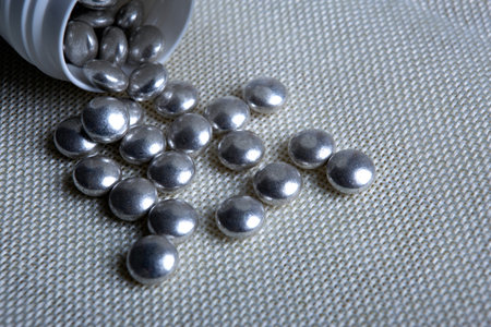 silver pills with a jar on a napkin close upの写真素材